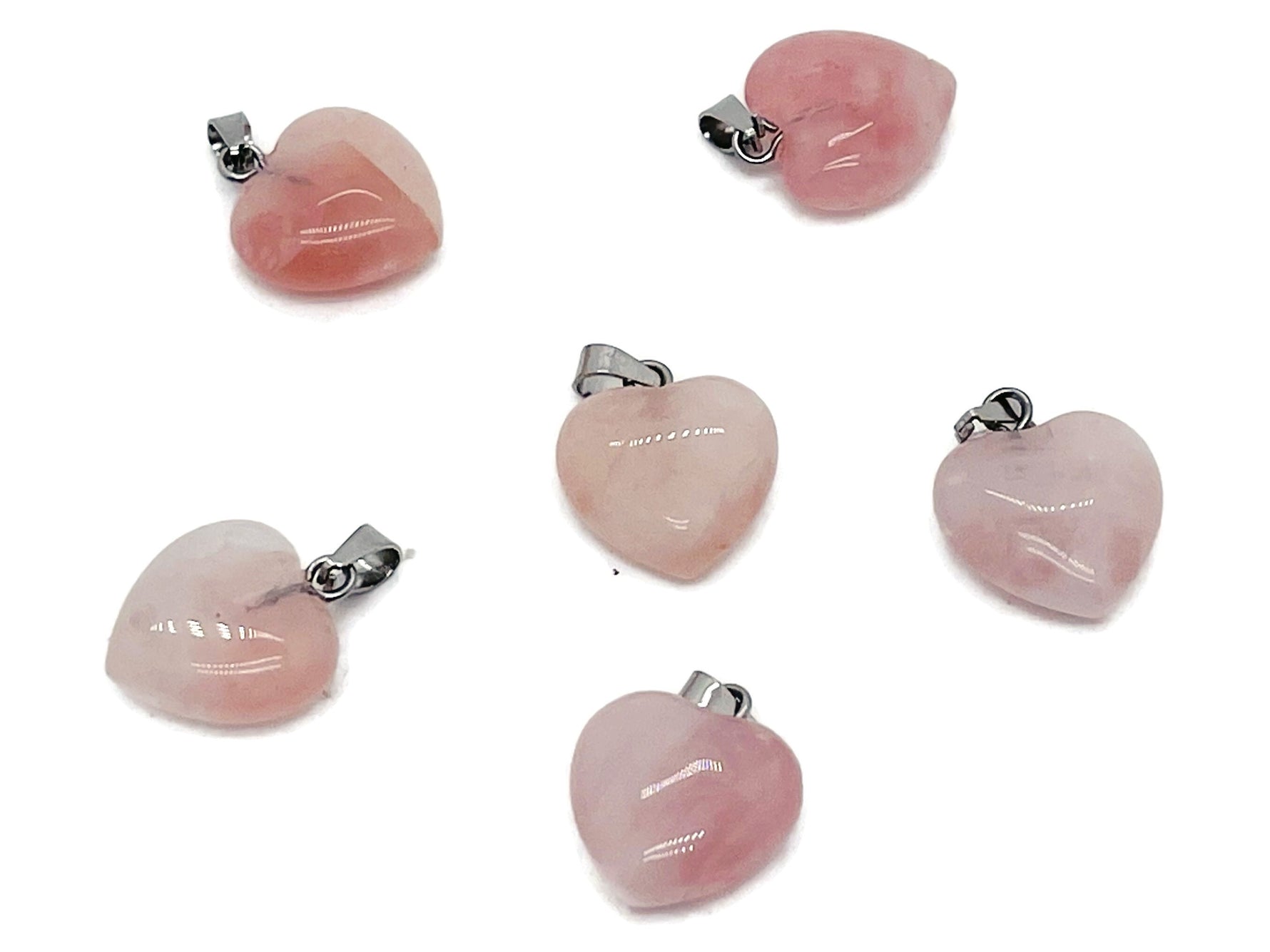Mini rose quartz heart pendant from GemstoneGO, showcasing a polished pink crystal crystal pendant on a silver chain.