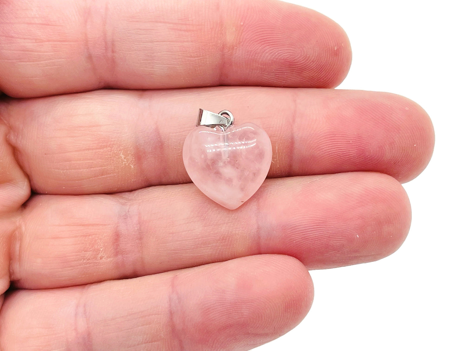 Mini rose quartz heart pendant from GemstoneGO, showcasing a pink crystal gemstone with a sleek silver bail.