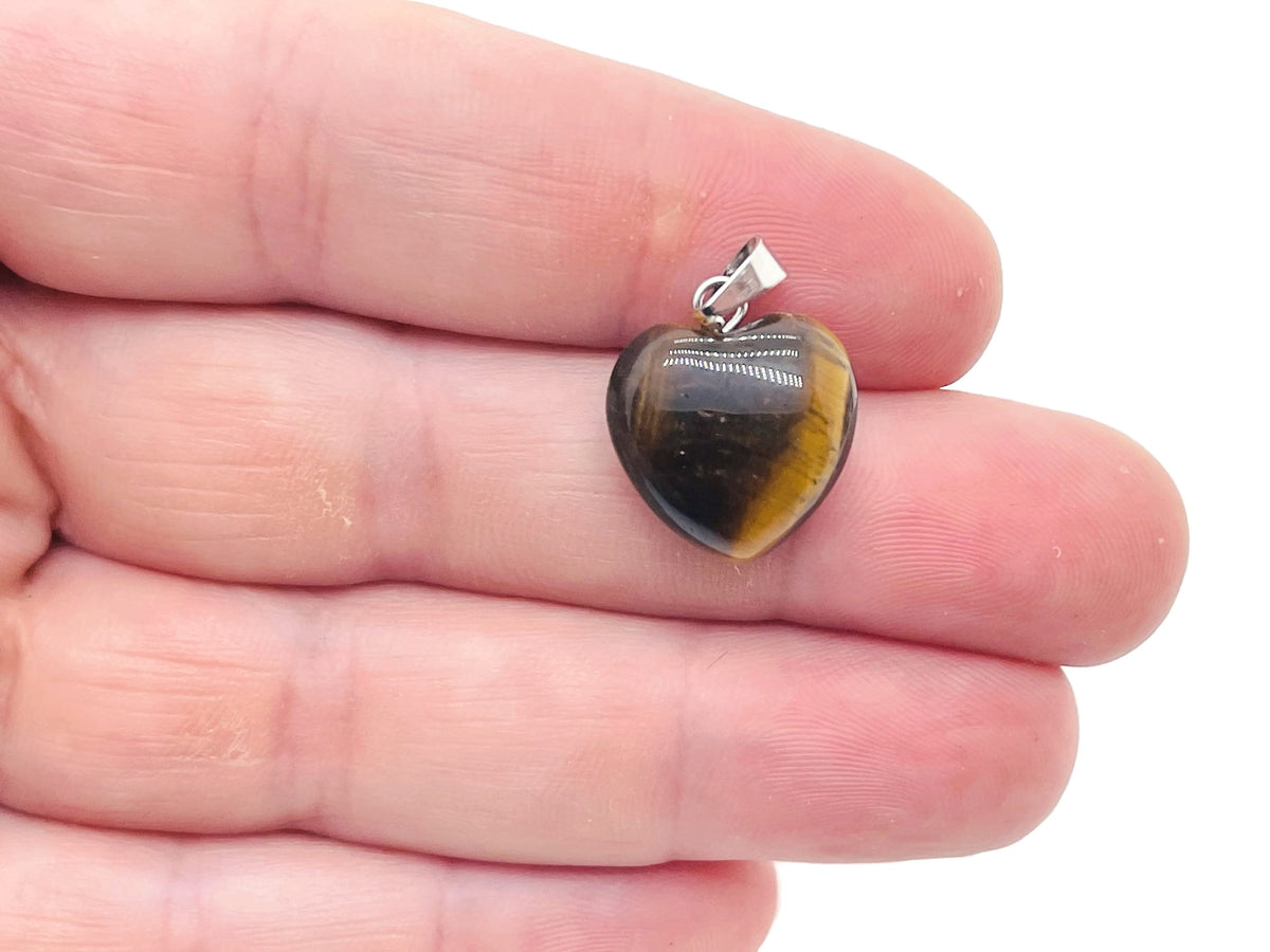 Tiger Eye heart pendant by GemstoneGO featuring a mini crystal gemstone in a polished heart shape.