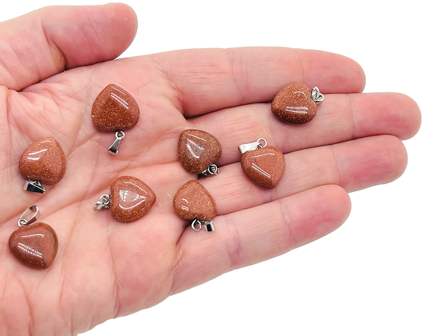Goldstone heart-shaped crystal pendant by GemstoneGO, featuring a mini sparkling gemstone with intricate details.