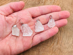 Clear quartz crystal pendant from GemstoneGO, showcasing a polished, transparent gemstone with silver bail on a white background.