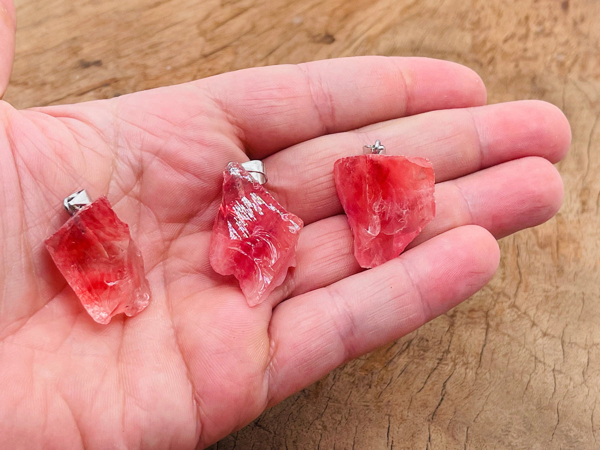 Cherry quartz crystal pendant from GemstoneGO featuring a vibrant red cherry-colored quartz gemstone with silver setting.