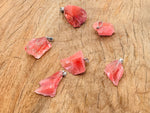 Cherry Quartz crystal pendant from GemstoneGO featuring a polished cherry-red quartz stone with a silver bail.
