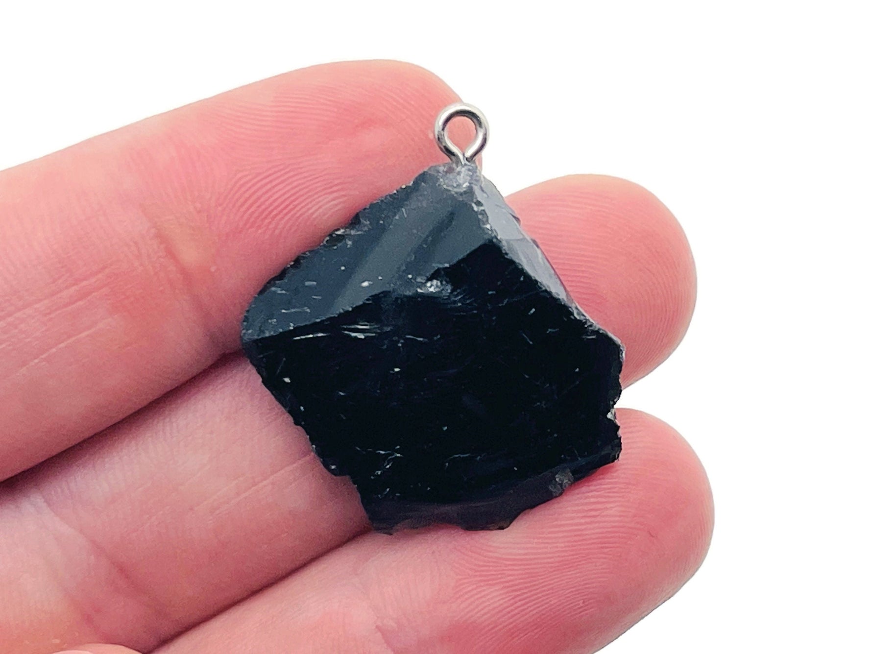 Obsidian crystal pendant from GemstoneGO featuring a polished black stone with natural veining on a silver chain.