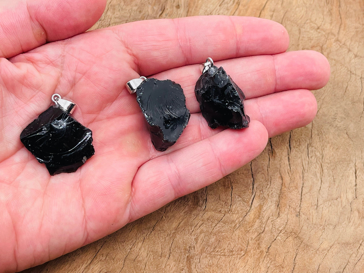 Obsidian crystal pendant from GemstoneGO featuring a polished black obsidian stone on a silver chain.