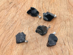 Obsidian crystal pendant from GemstoneGO featuring a polished black stone with natural veining and a silver bail.