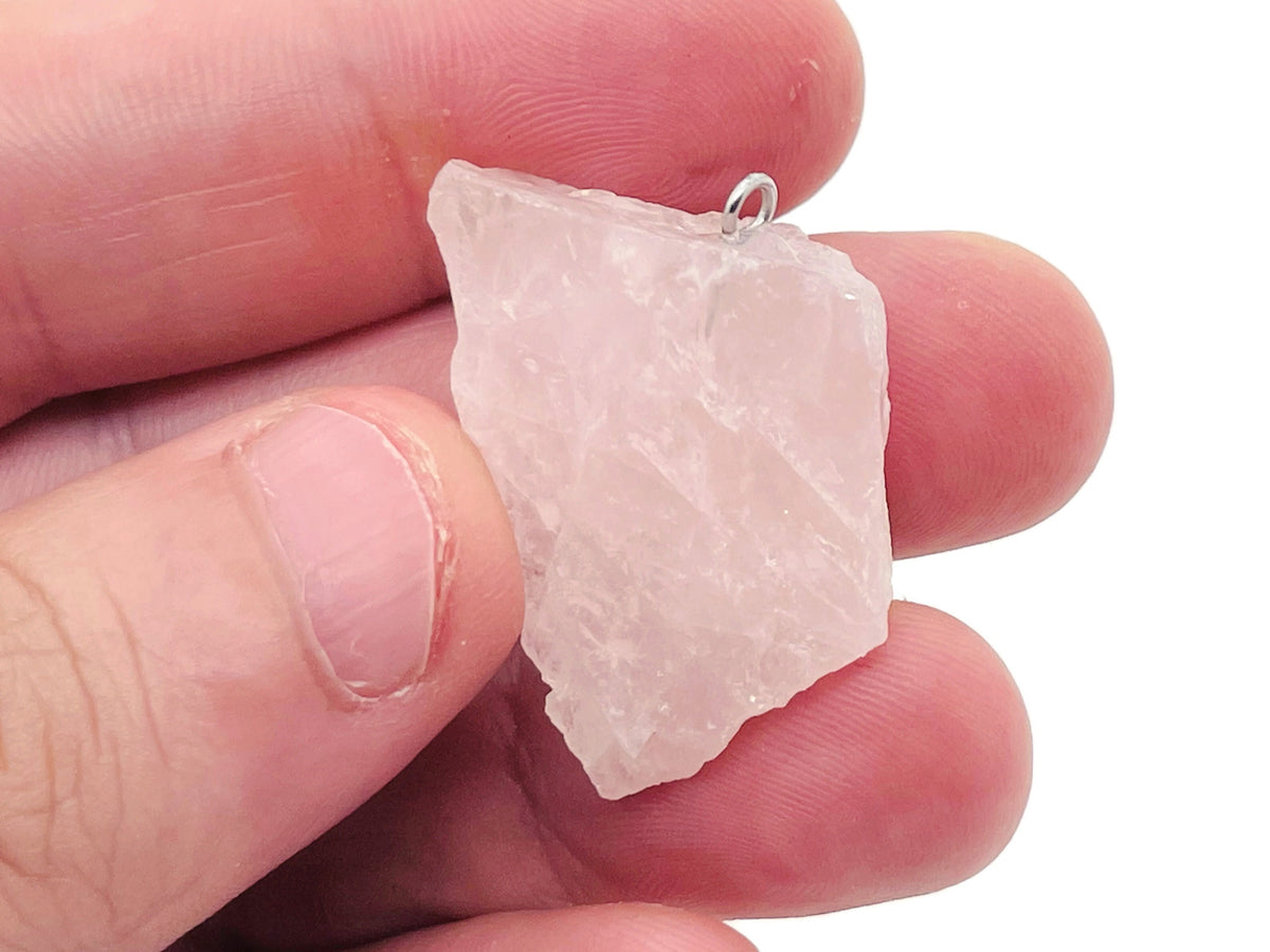 Rose Quartz crystal pendant from GemstoneGO featuring a polished pink gemstone on a silver chain.