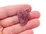Strawberry Quartz crystal pendant with a polished teardrop shape, featuring a silver bail and vibrant pink color, by GemstoneGO