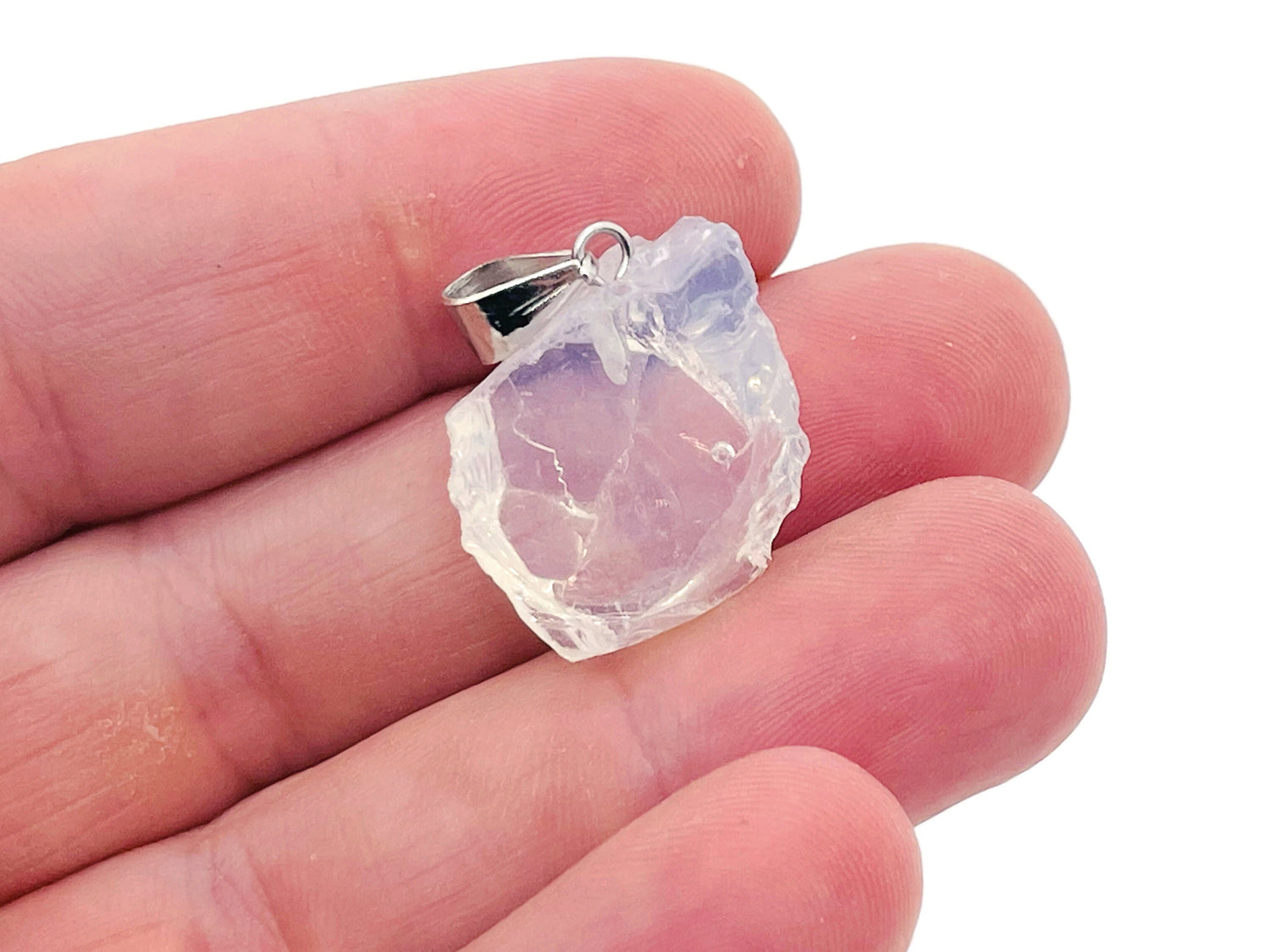 Opalite crystal pendant from GemstoneGO hanging on a silver chain, showcasing its smooth, glowing oval shape.