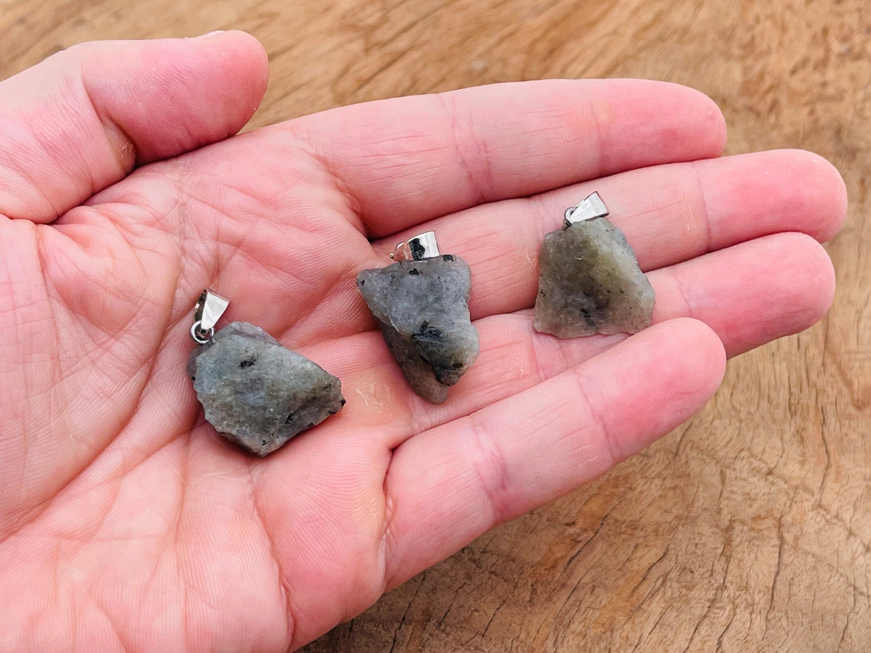 Labradorite crystal pendant from GemstoneGO featuring a polished, iridescent stone set in a silver-tone metal bail.