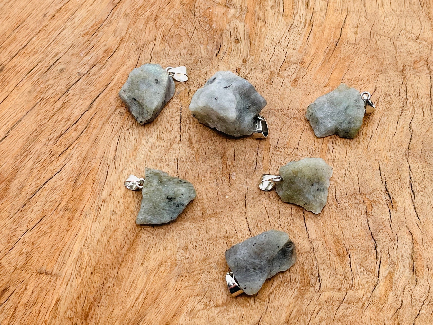 Labradorite crystal pendant from GemstoneGO featuring a polished, irregular-shaped gemstone on a silver chain.