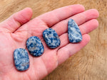 Blue Spot Jasper flat gemstone slab from GemstoneGO showing vibrant blue and brown mineral patterns on a smooth surface.