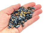 Blue tiger eye crystal chips, semi-tumbled 5-7mm gemstone from GemstoneGO, shown in close-up with vibrant blue and brown tones.