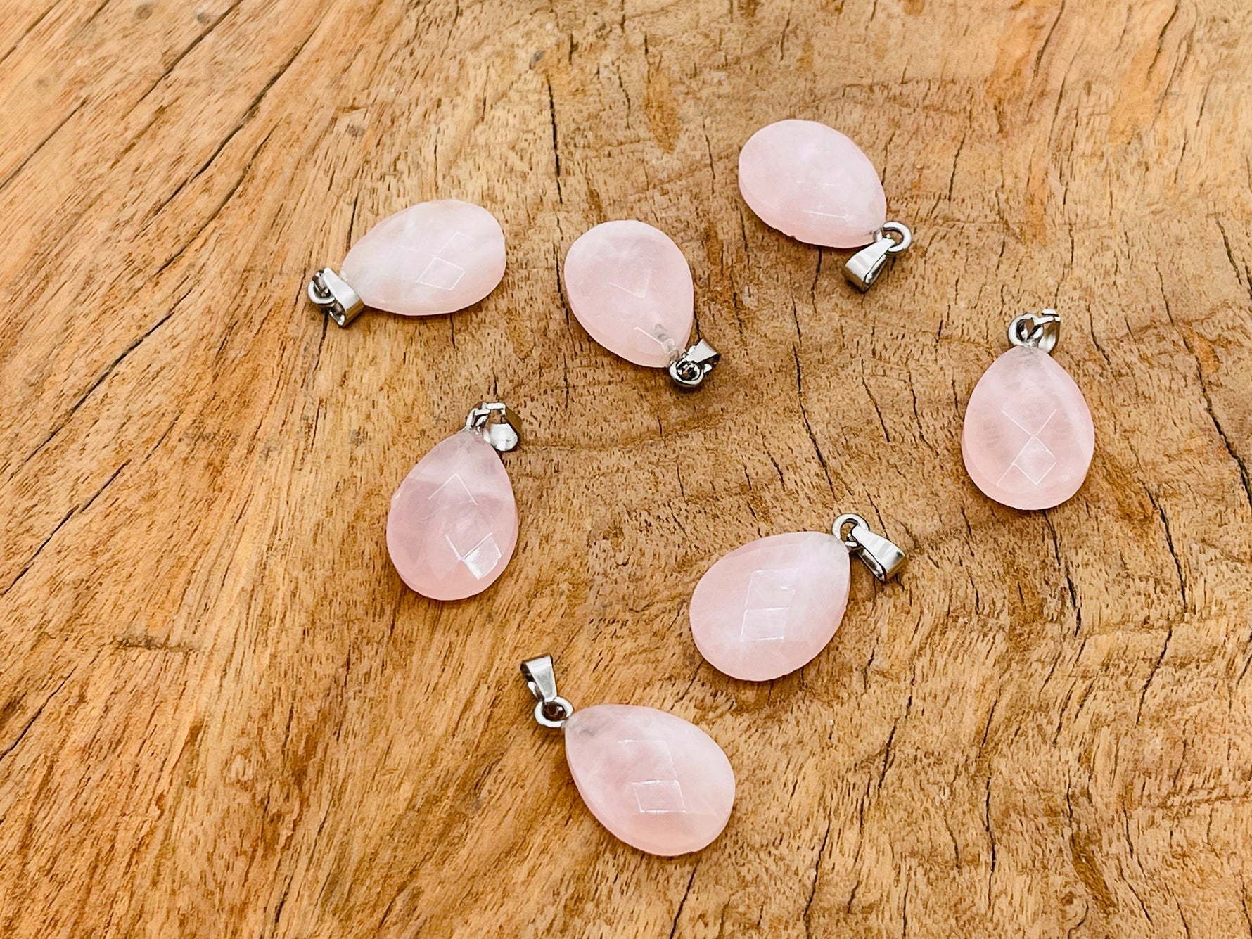 Rose quartz crystal pendant from GemstoneGO, 20mm, showcasing a smooth, polished pink gemstone for jewelry making.