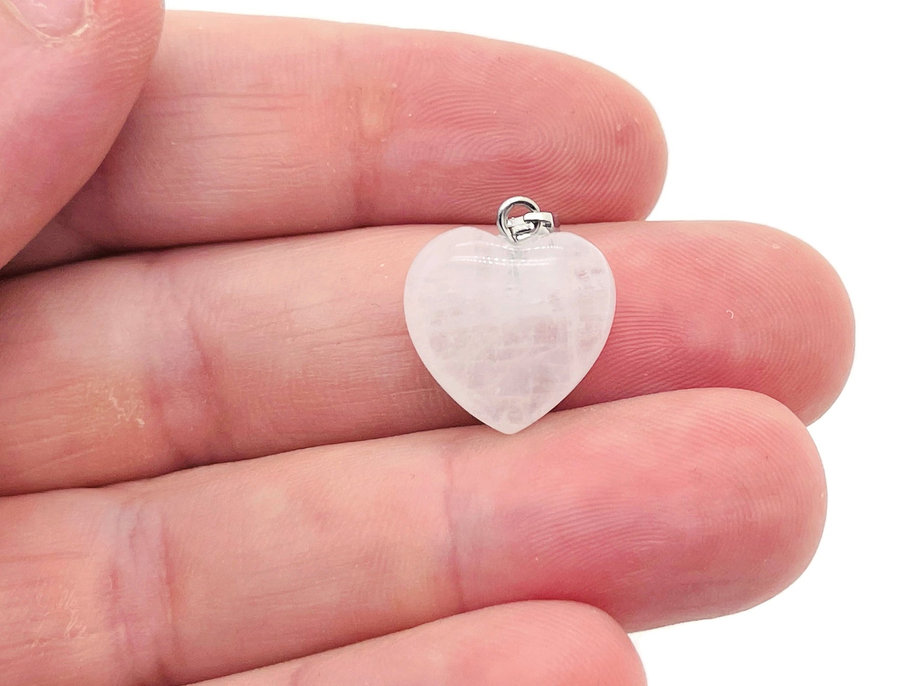 Clear quartz heart pendant from GemstoneGO, mini crystal jewelry featuring a polished, transparent stone on a delicate chain.