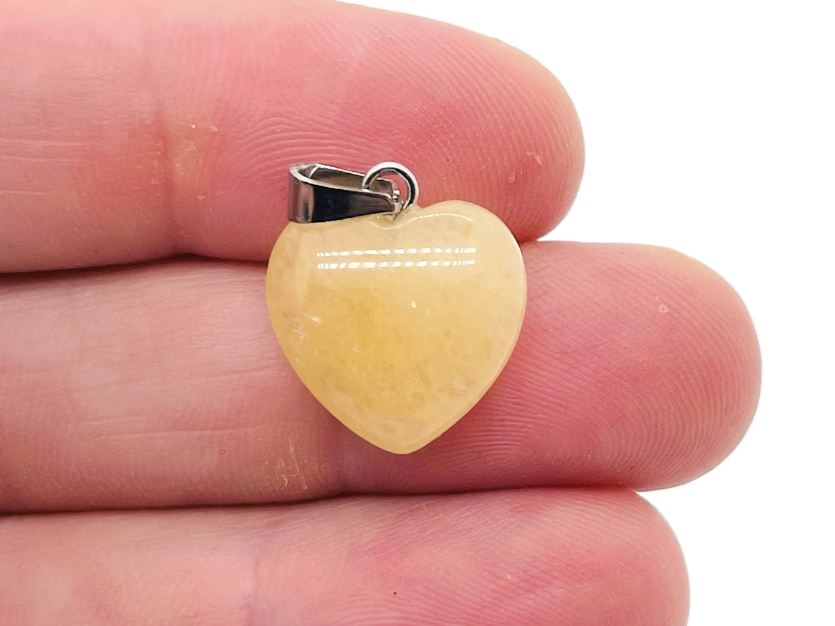Yellow jade heart pendant with a mini crystal accent, crafted by GemstoneGO, showcasing a polished, vibrant gemstone necklace.