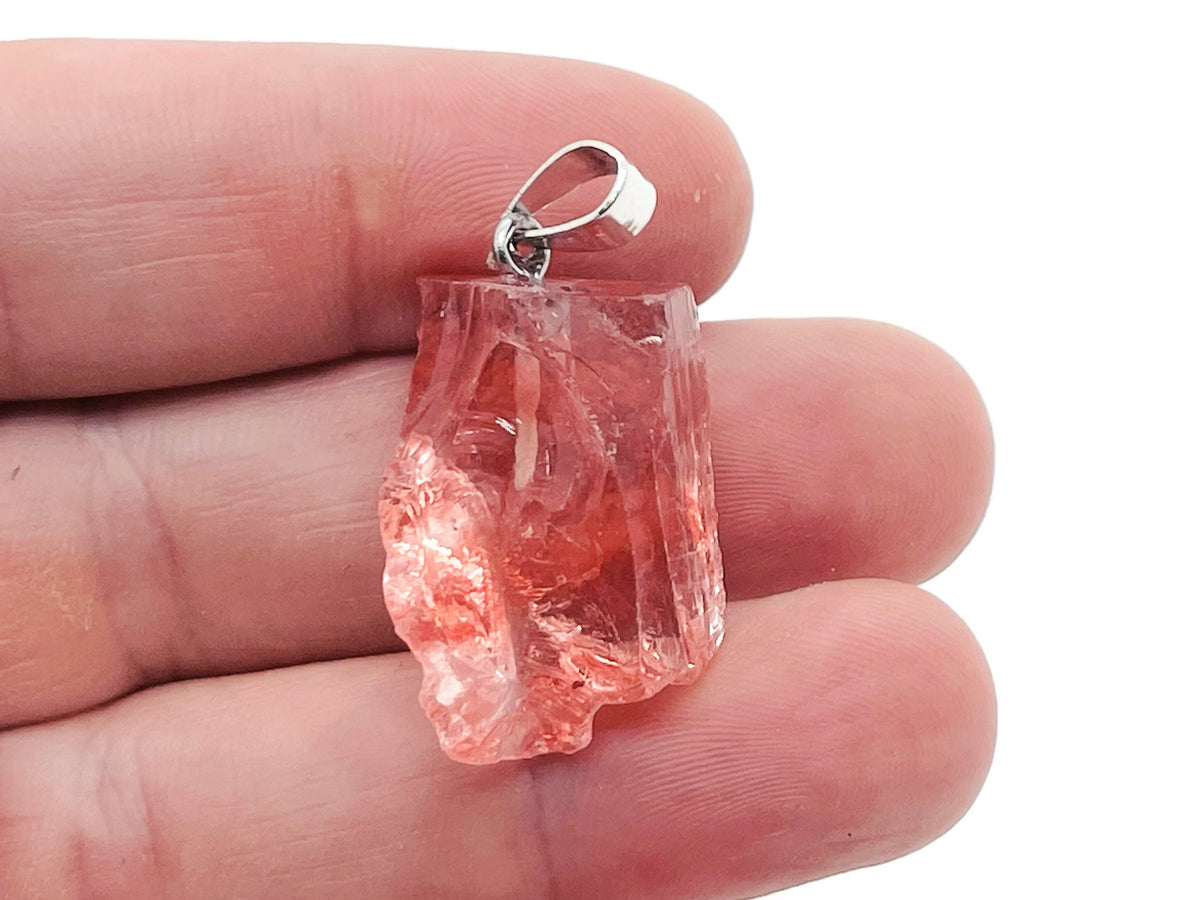 Cherry quartz crystal pendant with a polished cherry-red gemstone, featuring a silver bail for necklace attachment, by GemstoneGO.