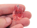 Cherry Quartz crystal pendant from GemstoneGO featuring a polished cherry-red quartz gemstone on a silver chain.