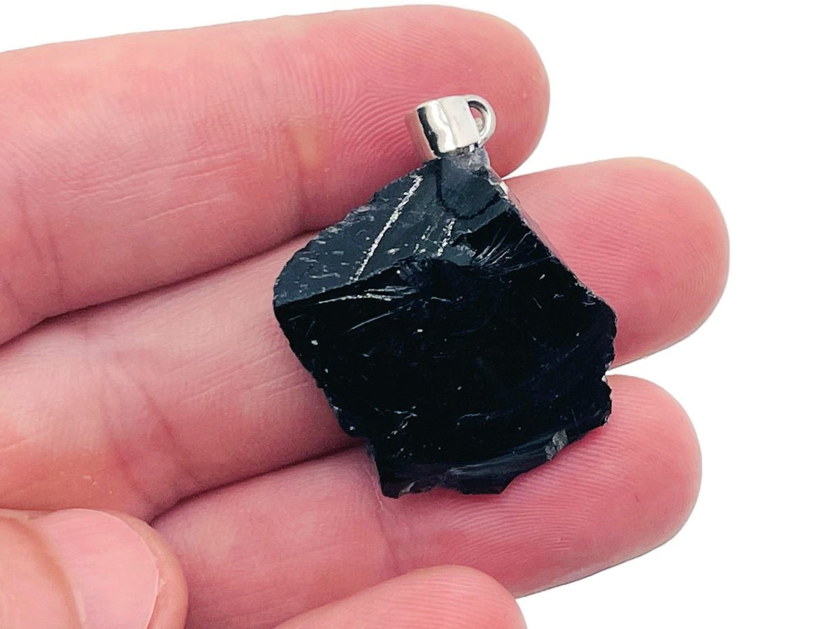 Obsidian crystal pendant from GemstoneGO featuring a polished black gemstone with a silver bail on a chain.