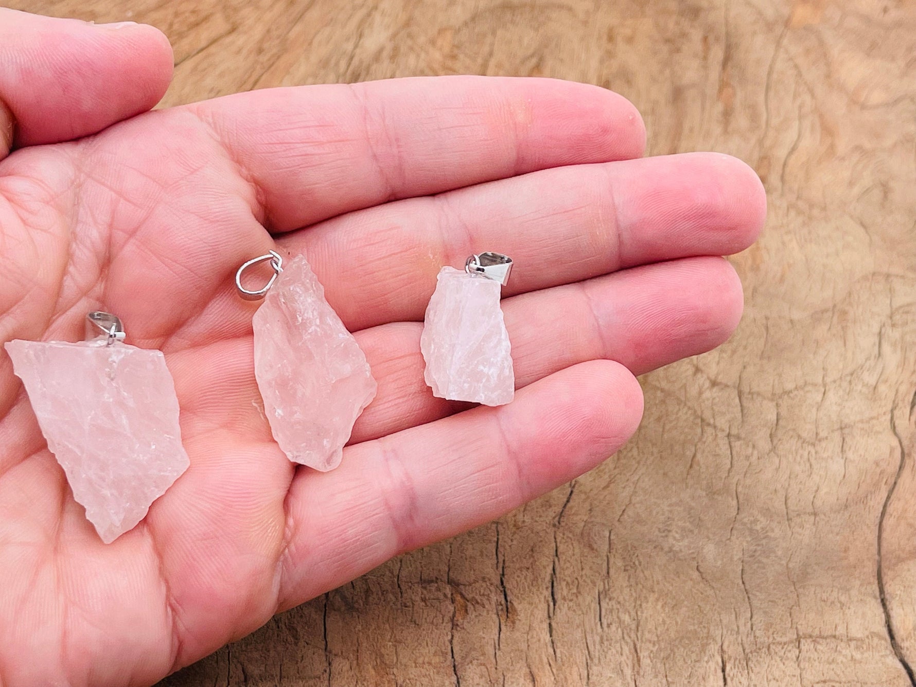 Rose quartz crystal pendant from GemstoneGO, featuring a polished pink gemstone on a delicate silver chain.