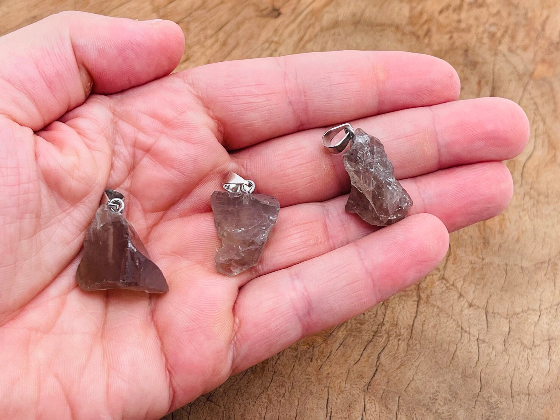 Smoky Quartz crystal pendant with silver bail from GemstoneGO, showcasing a polished, natural gemstone on a chain.