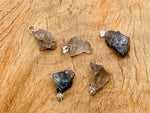 Smoky Quartz crystal pendant with natural gemstone setting, showcasing a polished, teardrop-shaped gemstone on a silver chain.