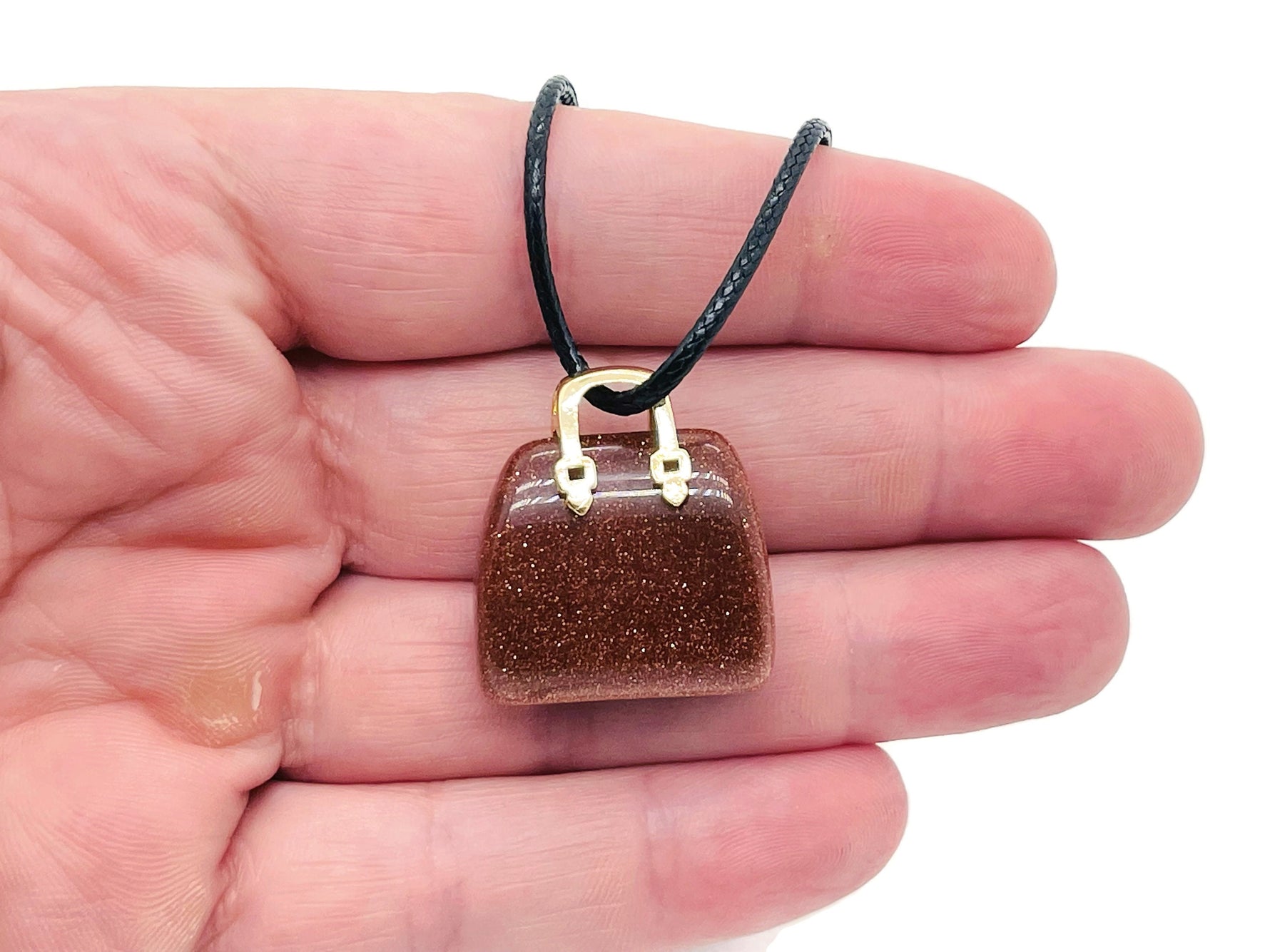 Goldstone crystal purse carving gemstone pendant, handcrafted crystal handbag jewelry by GemstoneGO, detailed and sparkling design.