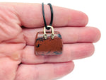 Mahogany Obsidian crystal purse carving gemstone pendant featuring a detailed handbag design, handcrafted by GemstoneGO.