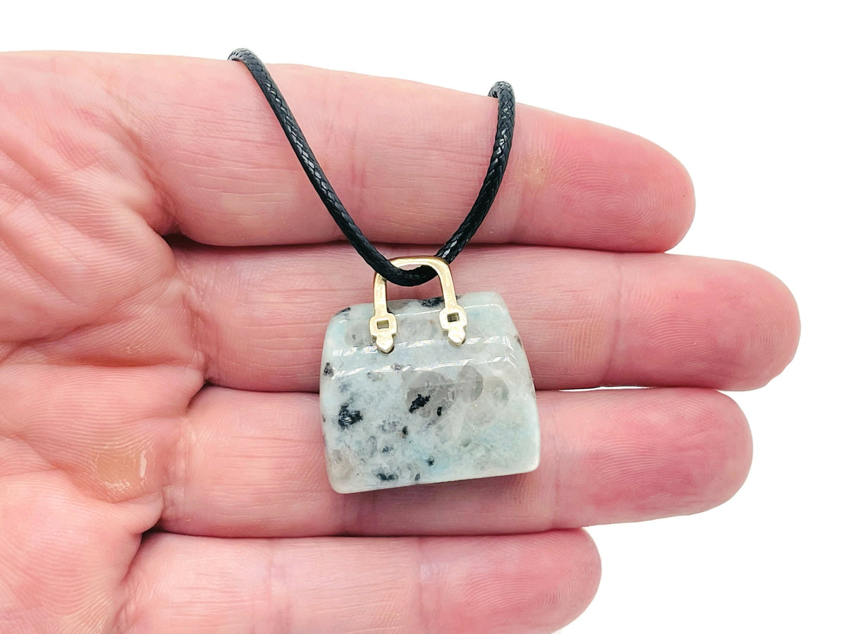Kiwi Jasper crystal handbag pendant with carved gemstone, showcasing detailed craftsmanship and vibrant green and brown hues.