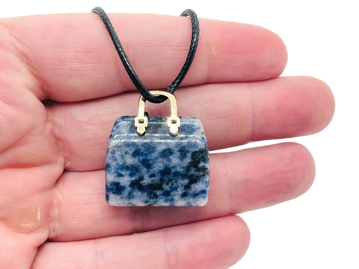 Blue Spot Jasper crystal purse carving with gemstone pendant, detailed close-up of the handcrafted gemstone handbag accessory.