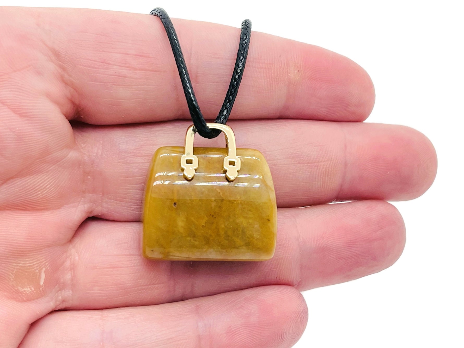 Yellow jade crystal purse carving gemstone pendant featuring a detailed handbag design, crafted by GemstoneGO.