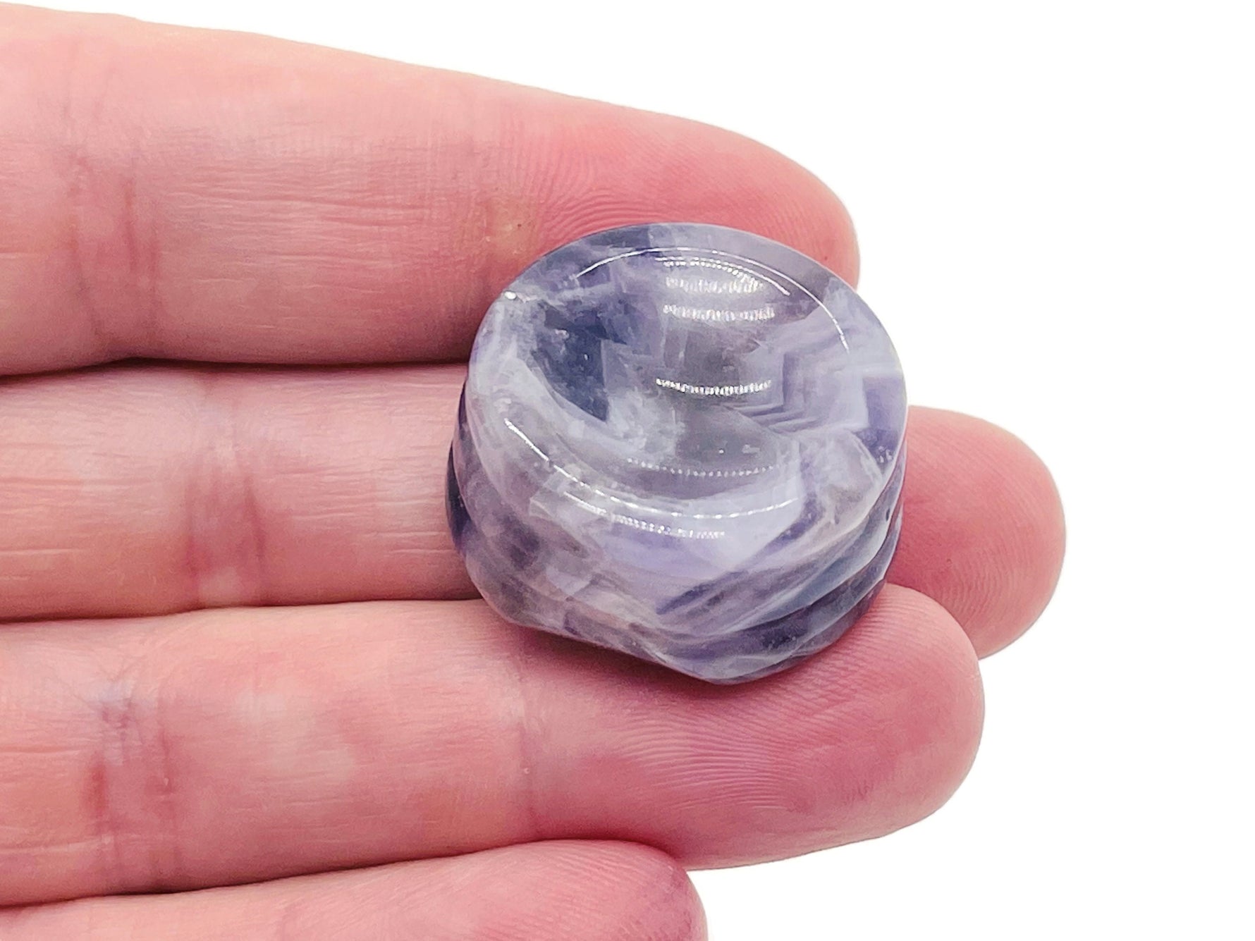 Amethyst crystal sphere on a carved gemstone stand, decorative home decor piece with purple gemstone and intricate wood base.