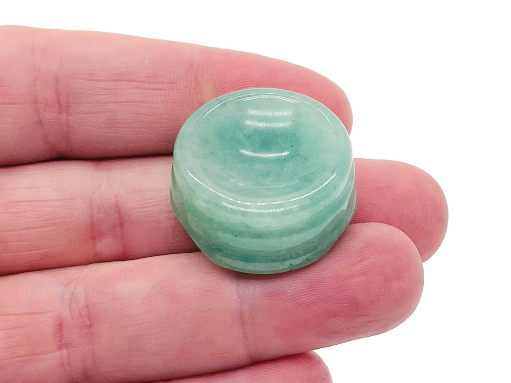 Aventurine crystal sphere on a carved gemstone stand, showcasing vibrant green hues, ideal for home decor display.