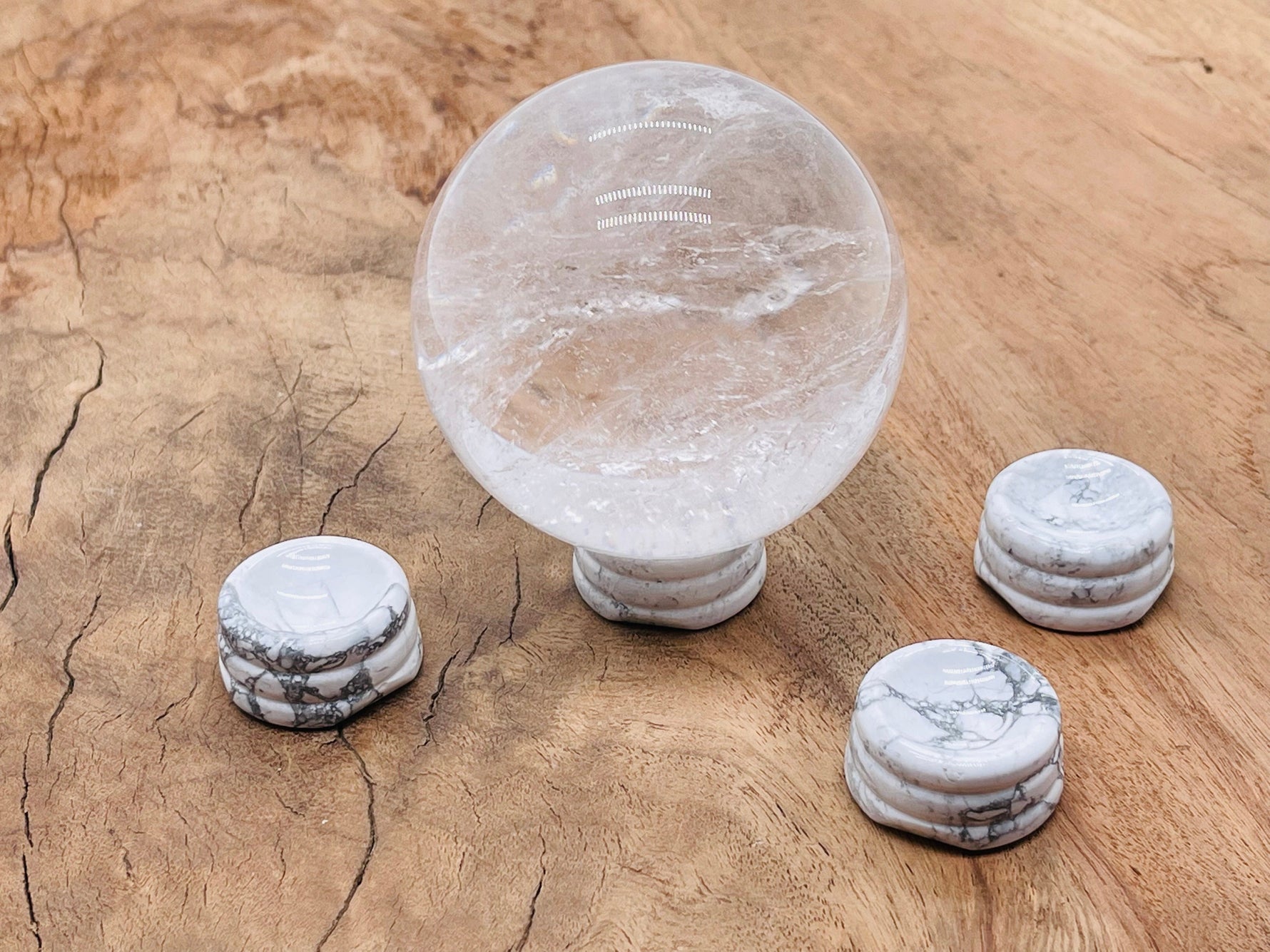 Carved Howlite crystal sphere on a decorative stand, perfect for home decor and gemstone display.