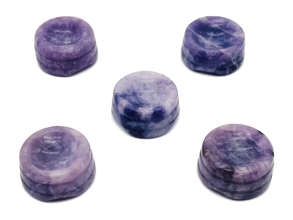 Lepidolite crystal sphere on carved gemstone stand, decorative home decor piece showcasing purple and pink hues.