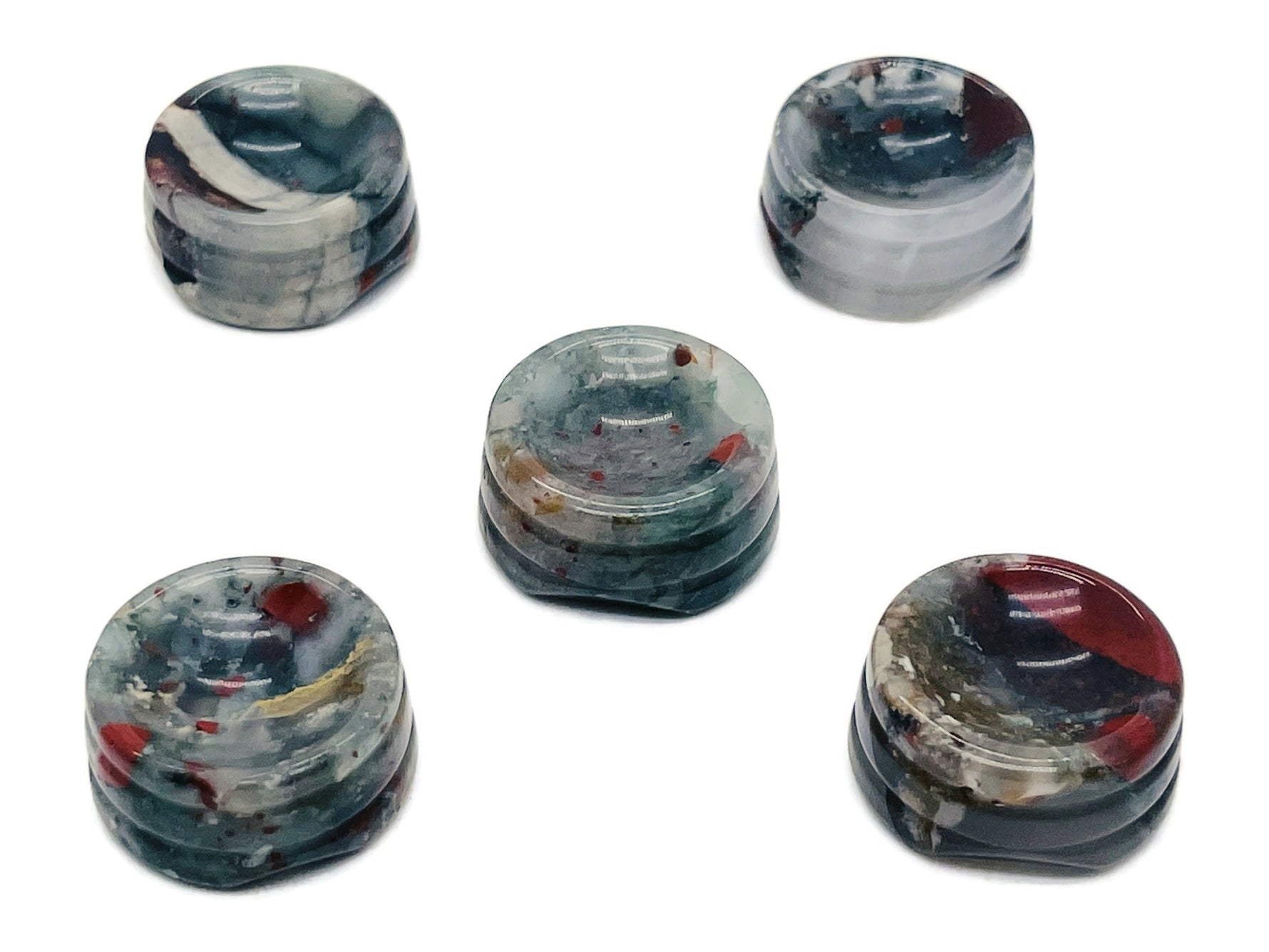 African Bloodstone crystal sphere on a carved gemstone stand, used as a decorative home accent with rich green and red hues.