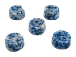 Blue Spot Jasper crystal sphere on carved gemstone stand, used as elegant home decor piece.