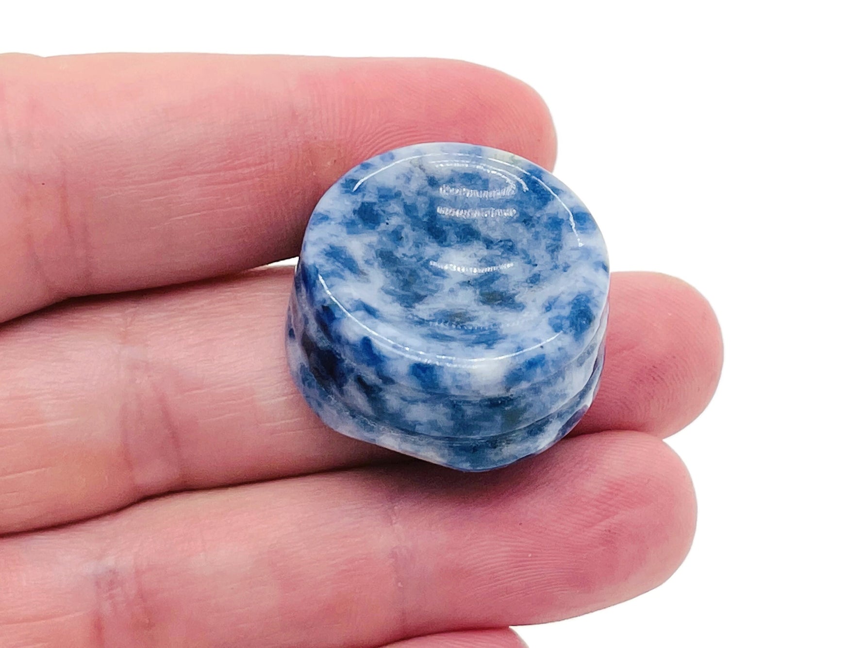 Blue Spot Jasper crystal sphere on a carved gemstone stand, used as a decorative home decor piece.