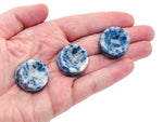 Blue Spot Jasper crystal sphere on a carved gemstone stand, used as elegant home decor piece.