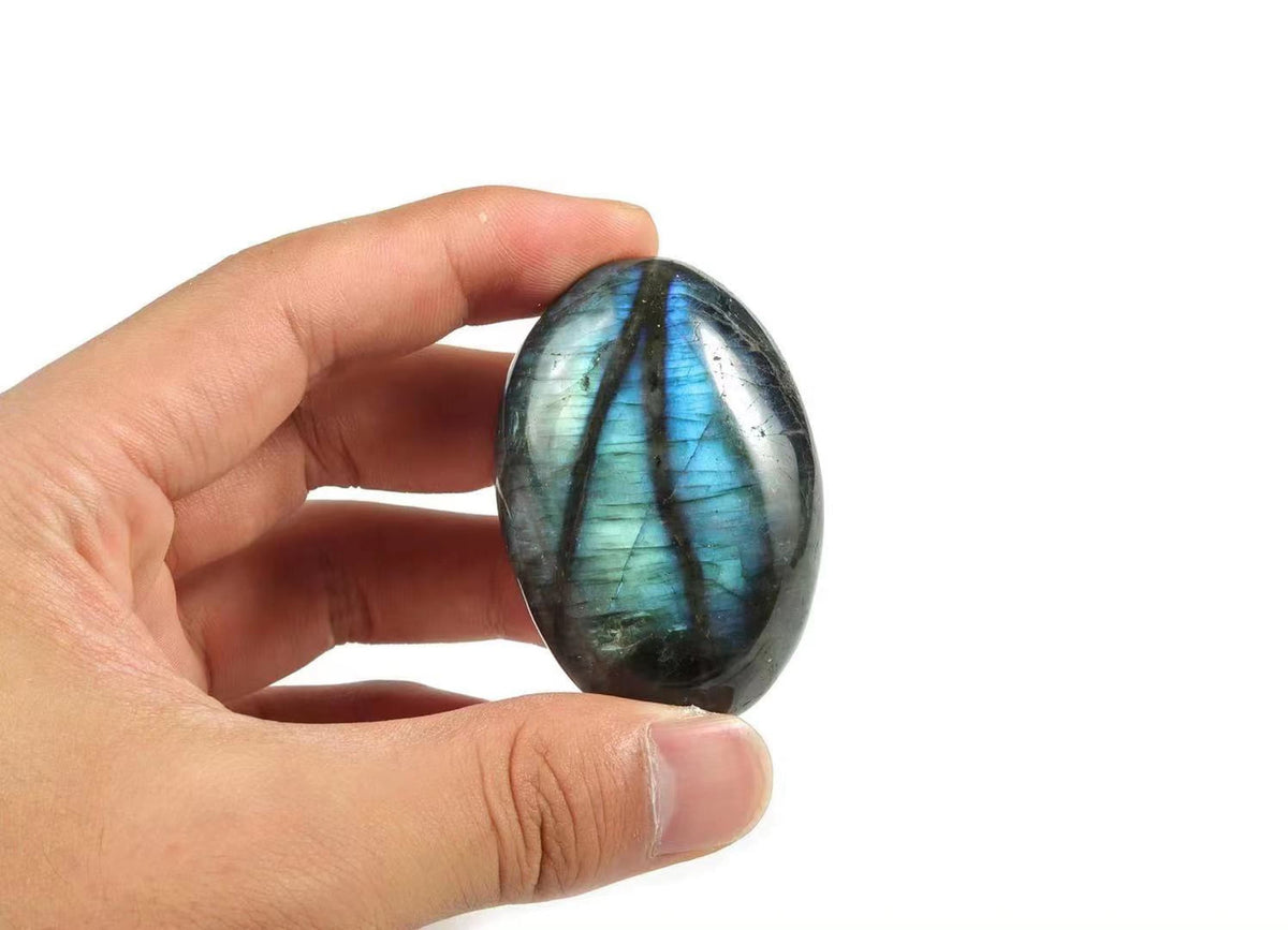 Labradorite palm gemstone spa stone by GemstoneGO, smooth polished stone with iridescent blue and green hues for relaxation and meditation.
