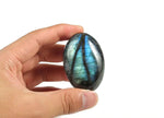 Labradorite palm gemstone spa stone by GemstoneGO, smooth polished stone with iridescent blue and green hues for relaxation and meditation.