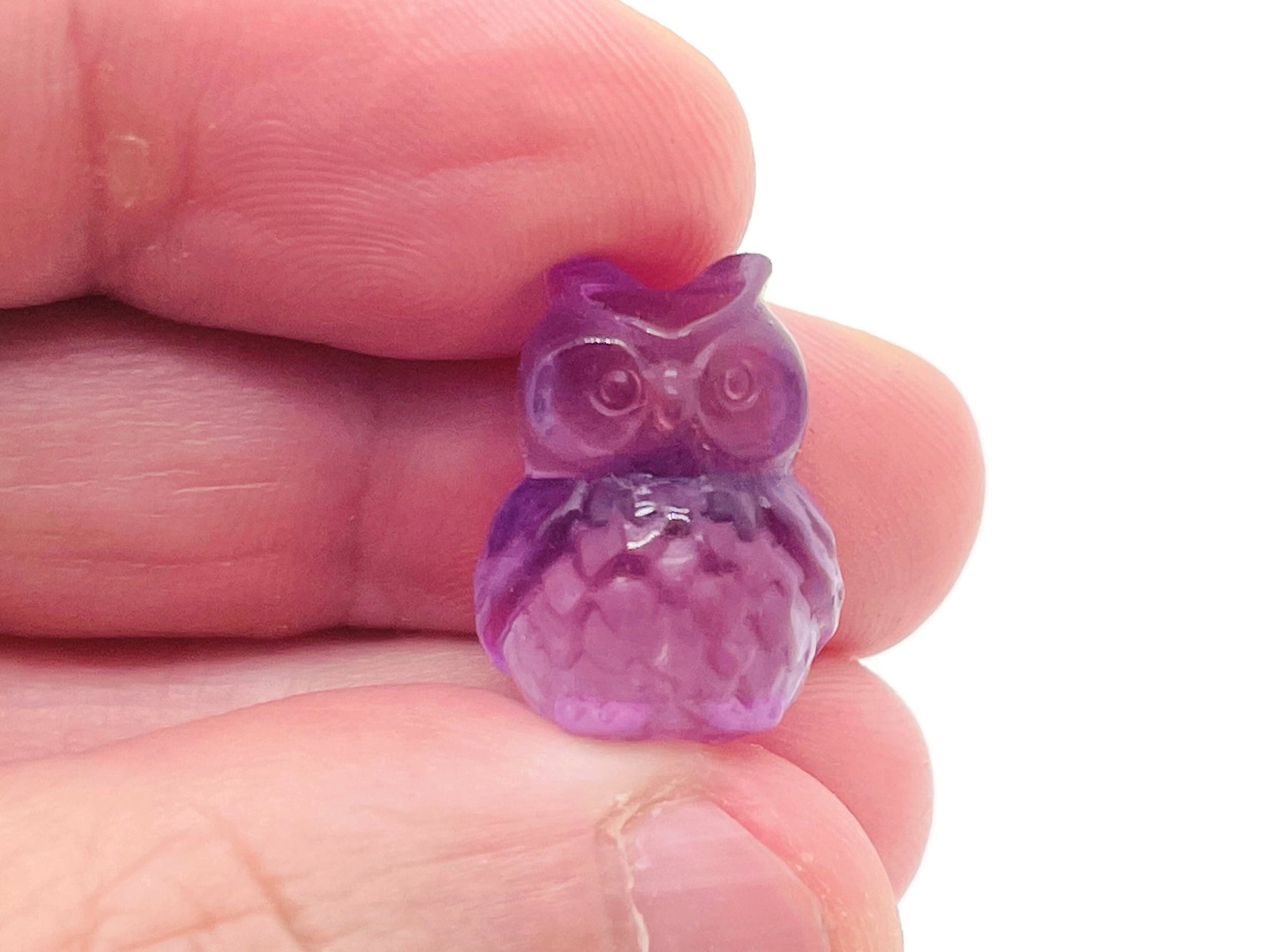 Fluorite owl carving gemstone by GemstoneGO, showing a colorful polished owl sculpture with vibrant purple, green, and blue hues.