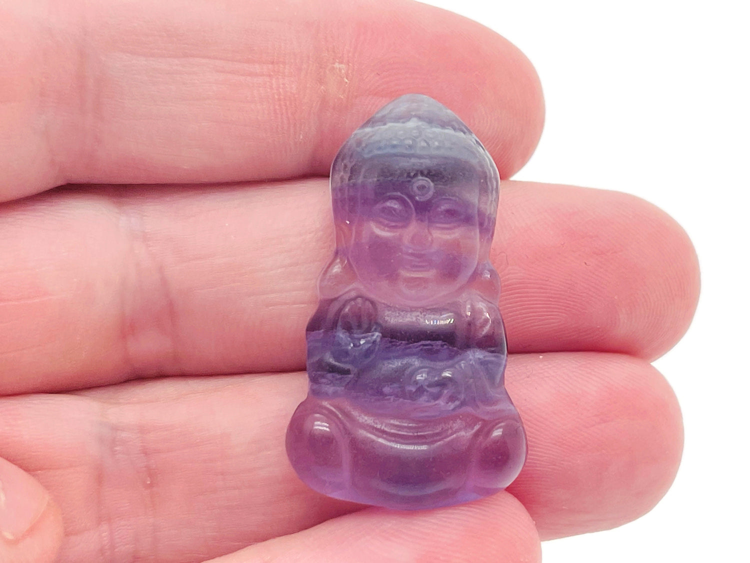 Fluorite Buddha carving gemstone from GemstoneGO, showing a colorful, polished Buddha figure carved from vibrant fluorite mineral.