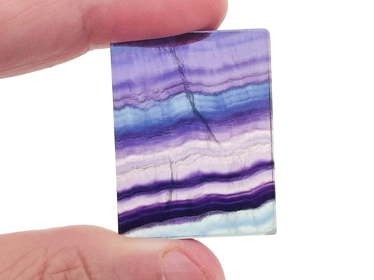 Fluorite slice slab gemstone from GemstoneGO showing vibrant purple, green, and blue hues with natural crystalline patterns.