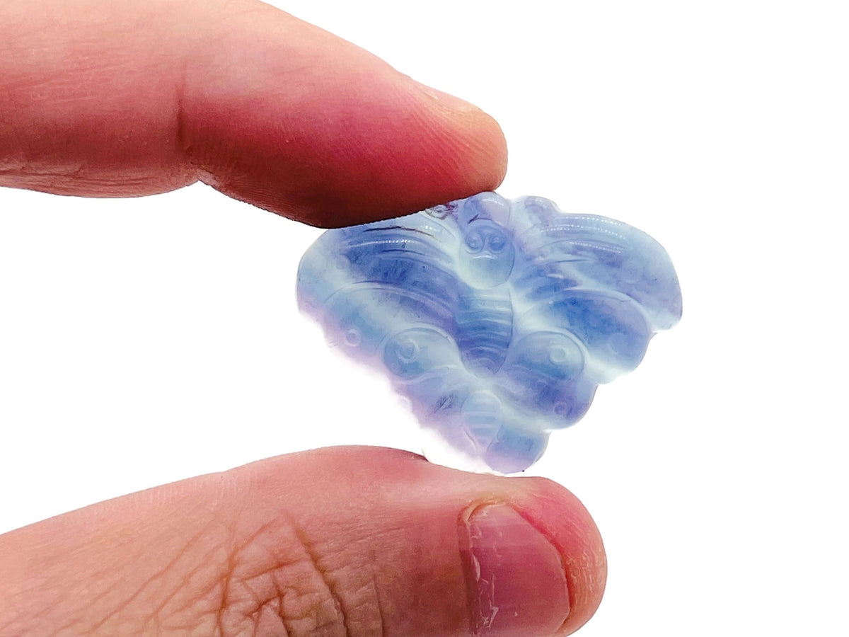 Fluorite butterfly carving gemstone from GemstoneGO, showcasing vibrant purple and green hues with detailed butterfly design.