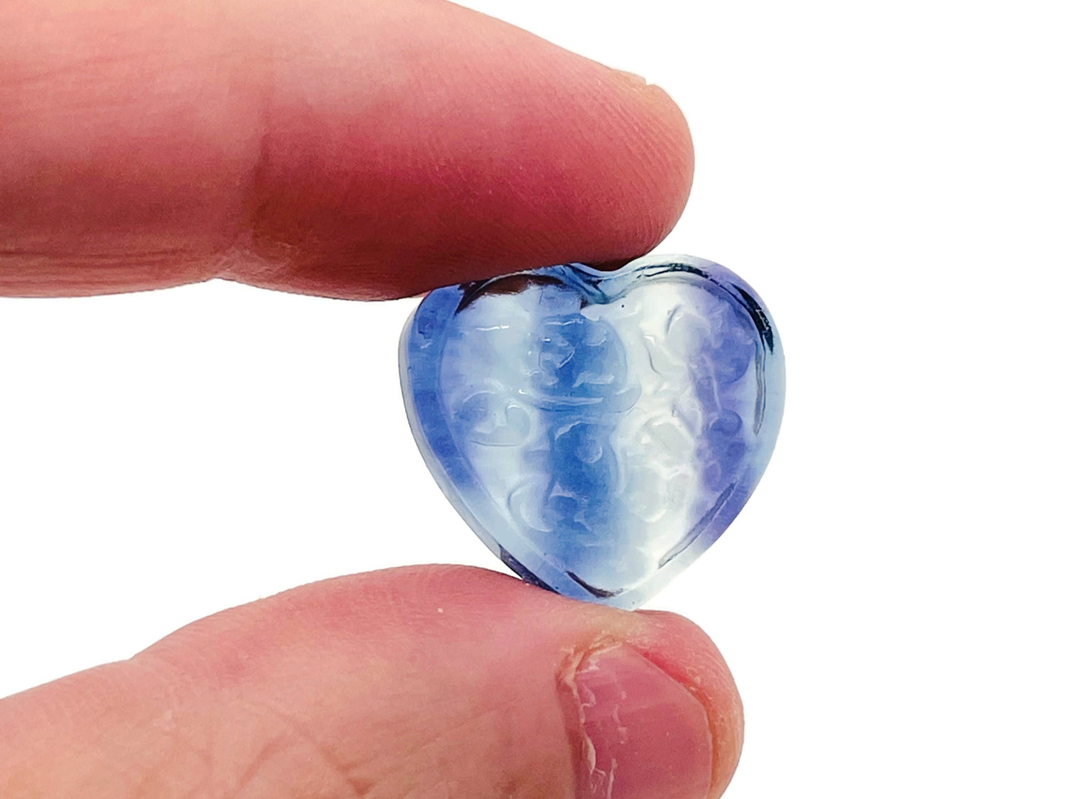 Polished fluorite heart-shaped gemstone carving from GemstoneGO, vibrant purple and green hues with smooth, detailed surface.