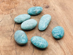 Amazonite palm gemstone spa stone from GemstoneGO, smooth and polished for massage and relaxation.