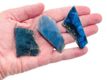 Labradorite flat gemstone slab from GemstoneGO showcasing iridescent blue and green hues in a polished crystal piece.