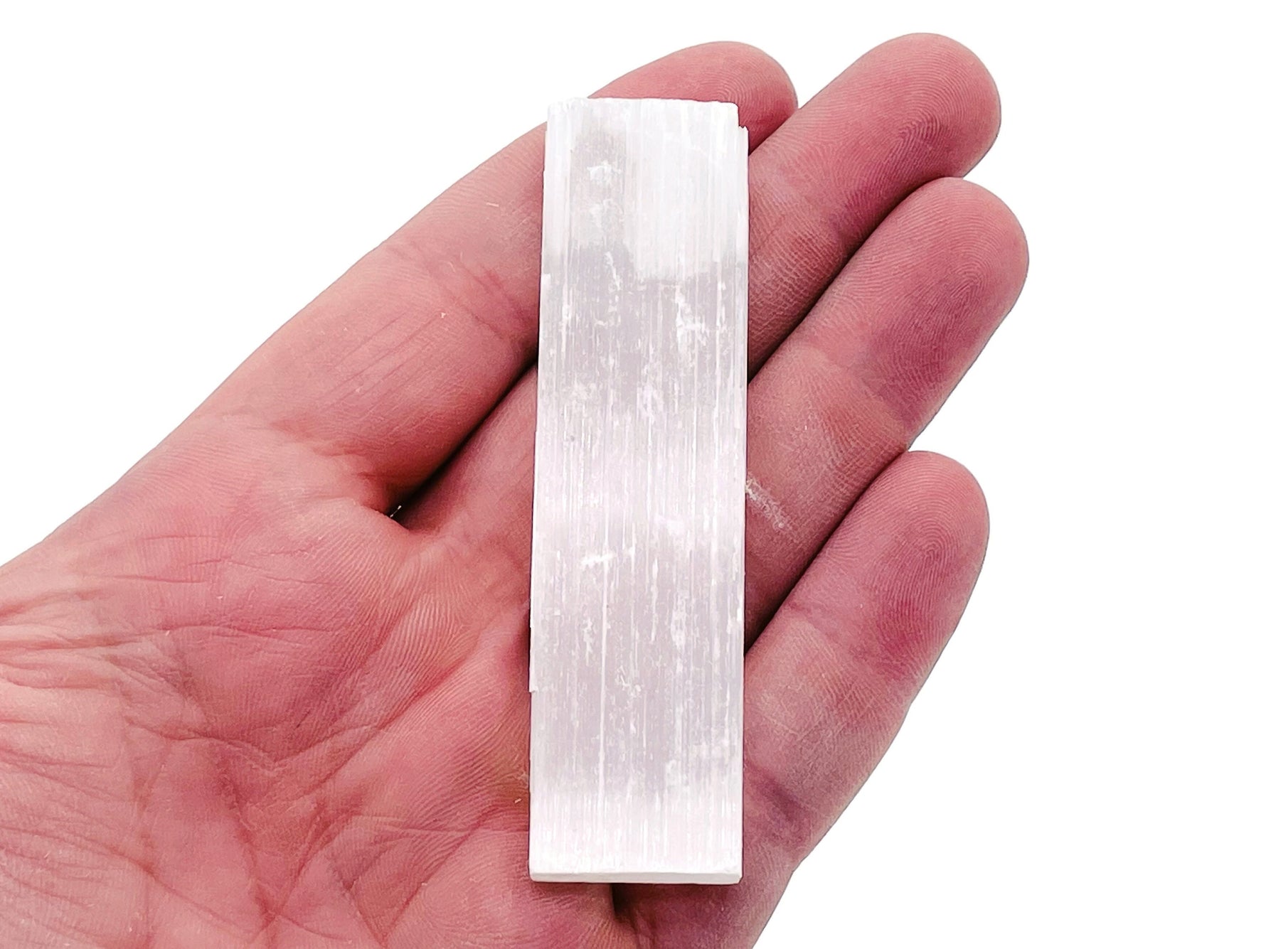 Raw Selenite wand in various lengths from GemstoneGO, showcasing its translucent, natural stick shape and smooth surface.