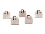 Rose quartz crystal gemstone carved as a handbag pendant, featuring detailed carvings and a polished finish.